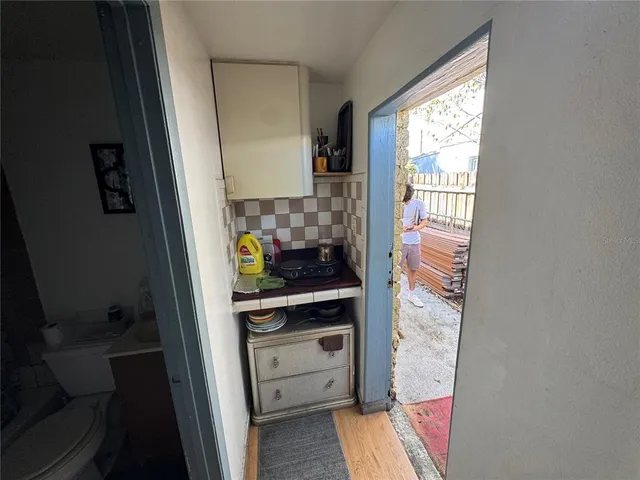 a bedroom with a bed and a lamp on dresser