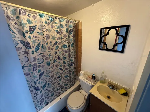 a view of a backyard with plants and a fire pit