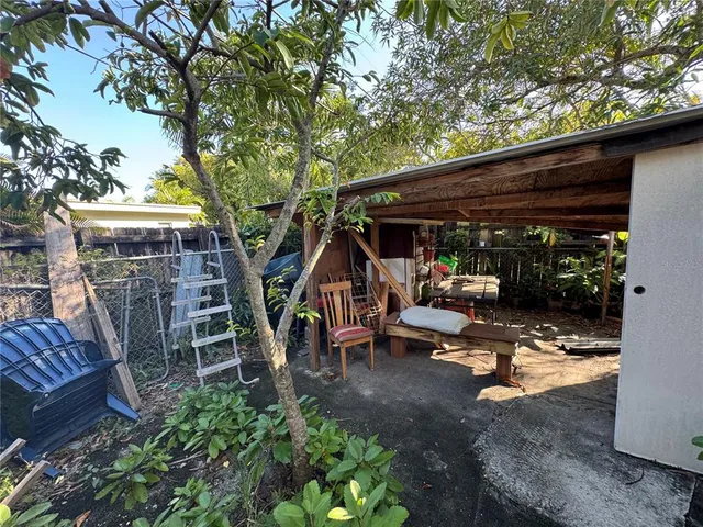a backyard of a house with table and chairs