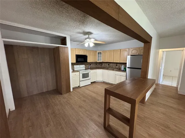 a view of kitchen with cabinets and wooden floor