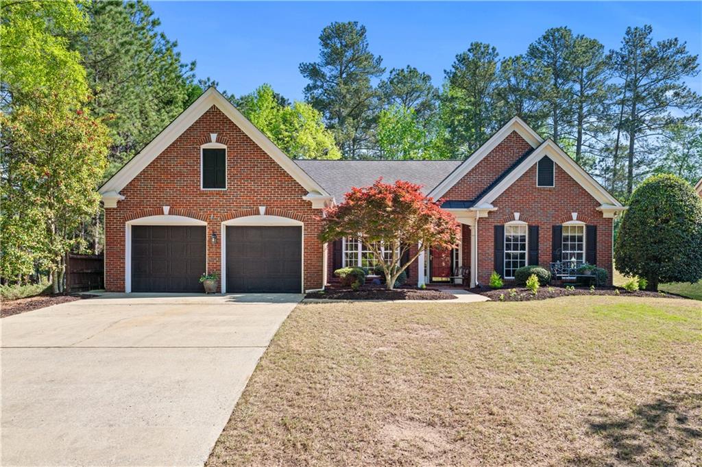 1315 Badingham Drive Cumming, GA 30041 - Photo 1 of 1 a front view of a house with a yard and trees