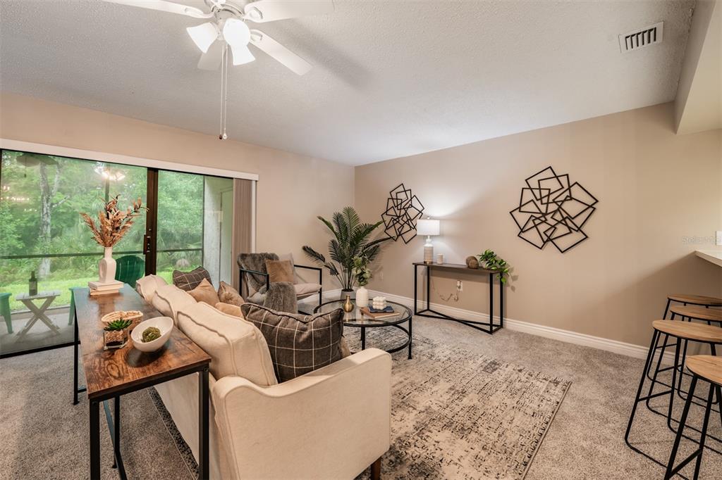 1801 East Lake Road South, Unit 6D Palm Harbor, FL 34685 - Photo 3 of 24 a living room with furniture and a large window
