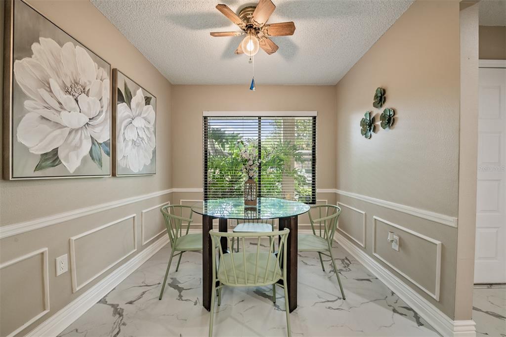 1801 East Lake Road South, Unit 6D Palm Harbor, FL 34685 - Photo 4 of 24 a view of a dining room with furniture window and outside view