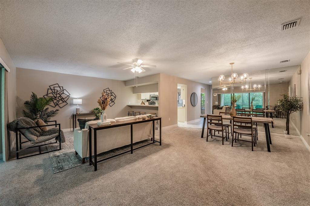 1801 East Lake Road South, Unit 6D Palm Harbor, FL 34685 - Photo 5 of 24 a living room with furniture and a table