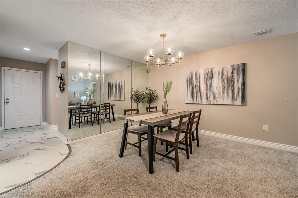 1801 East Lake Road South, Unit 6D Palm Harbor, FL 34685 - Photo 7 of 24 a view of a dining room with furniture