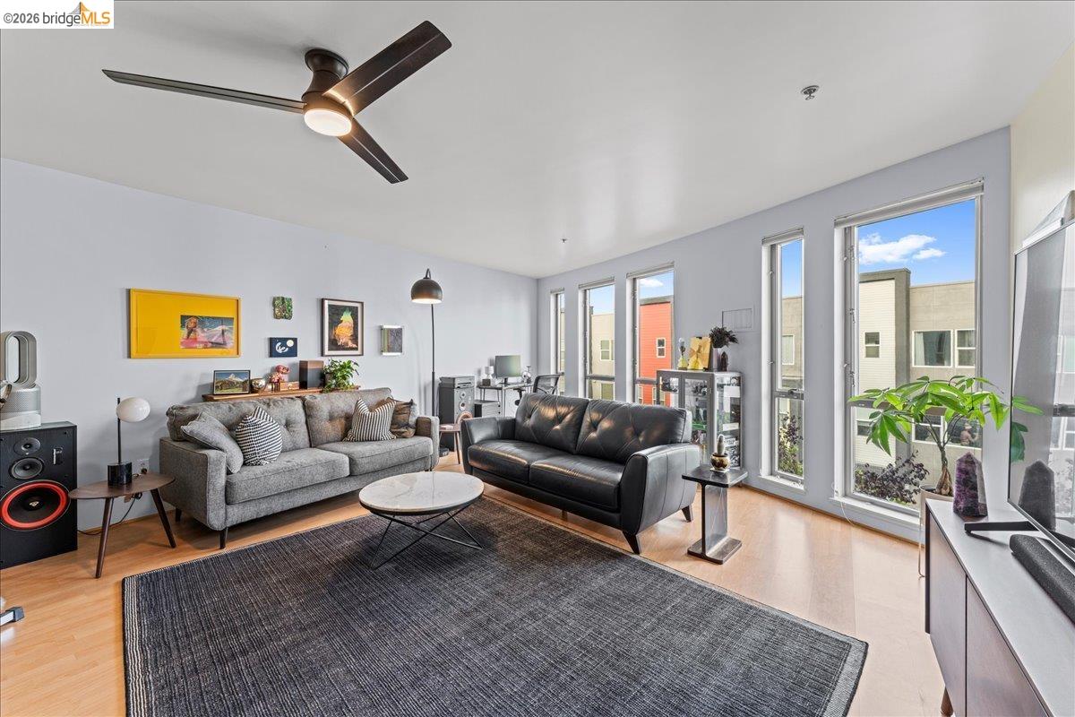 1201 Pine Street, Unit 354 Oakland, CA 94607 - Photo 1 of 26 a living room with furniture and a large window