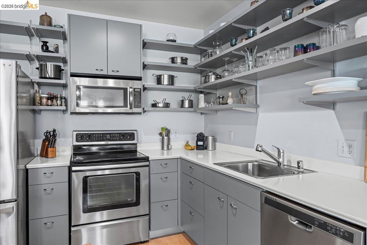 1201 Pine Street, Unit 354 Oakland, CA 94607 - Photo 19 of 26 a kitchen with cabinets a sink and appliances
