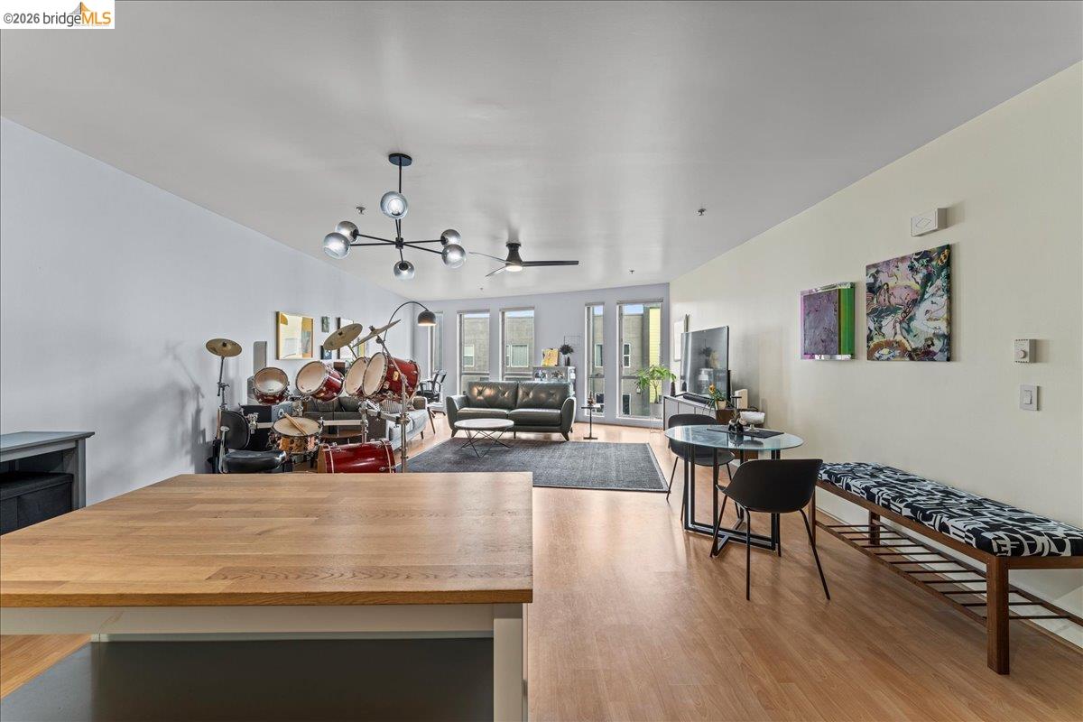 1201 Pine Street, Unit 354 Oakland, CA 94607 - Photo 20 of 26 a view of a dining room with furniture chandelier and wooden floor