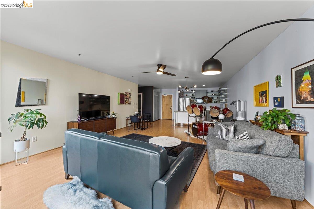 1201 Pine Street, Unit 354 Oakland, CA 94607 - Photo 2 of 26 a living room with furniture and a flat screen tv