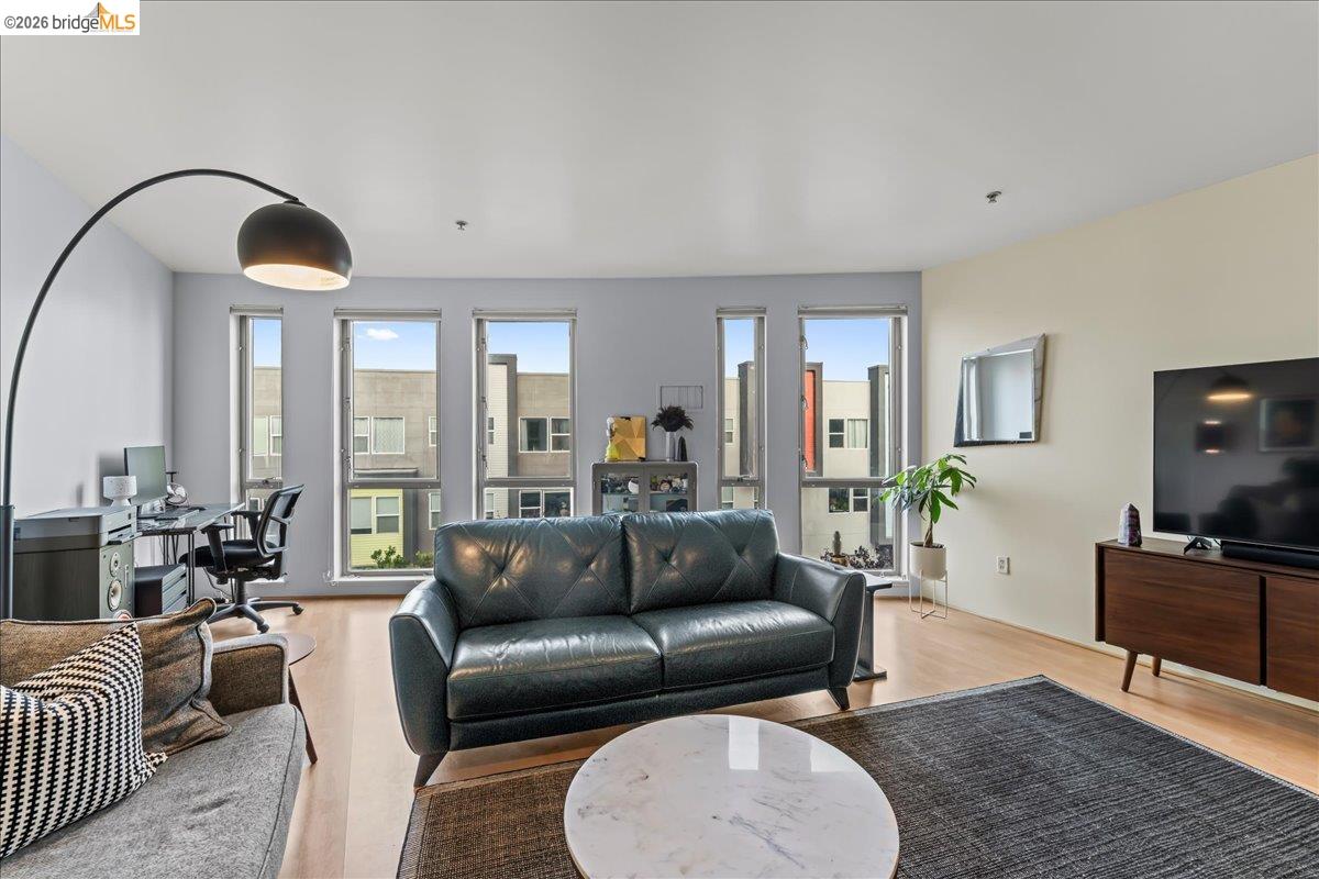1201 Pine Street, Unit 354 Oakland, CA 94607 - Photo 23 of 26 a living room with furniture and a large window
