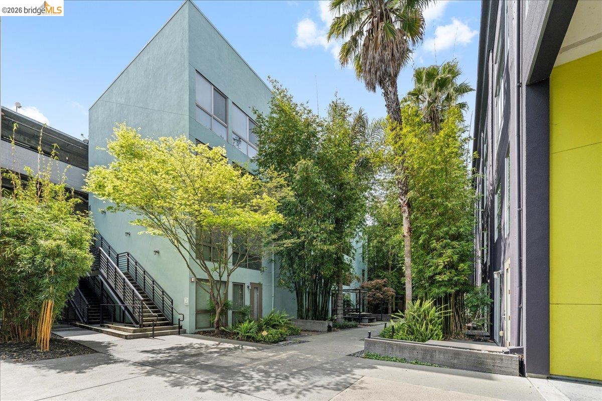 1201 Pine Street, Unit 354 Oakland, CA 94607 - Photo 3 of 26 a front view of a building with garden