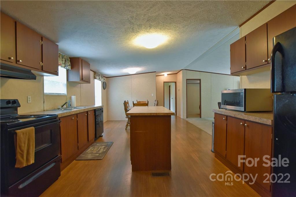 191 East Bells Branch Road Blacksburg, SC 29702 - Photo 6 of 14 a large kitchen with stainless steel appliances wooden cabinets a sink and a stove