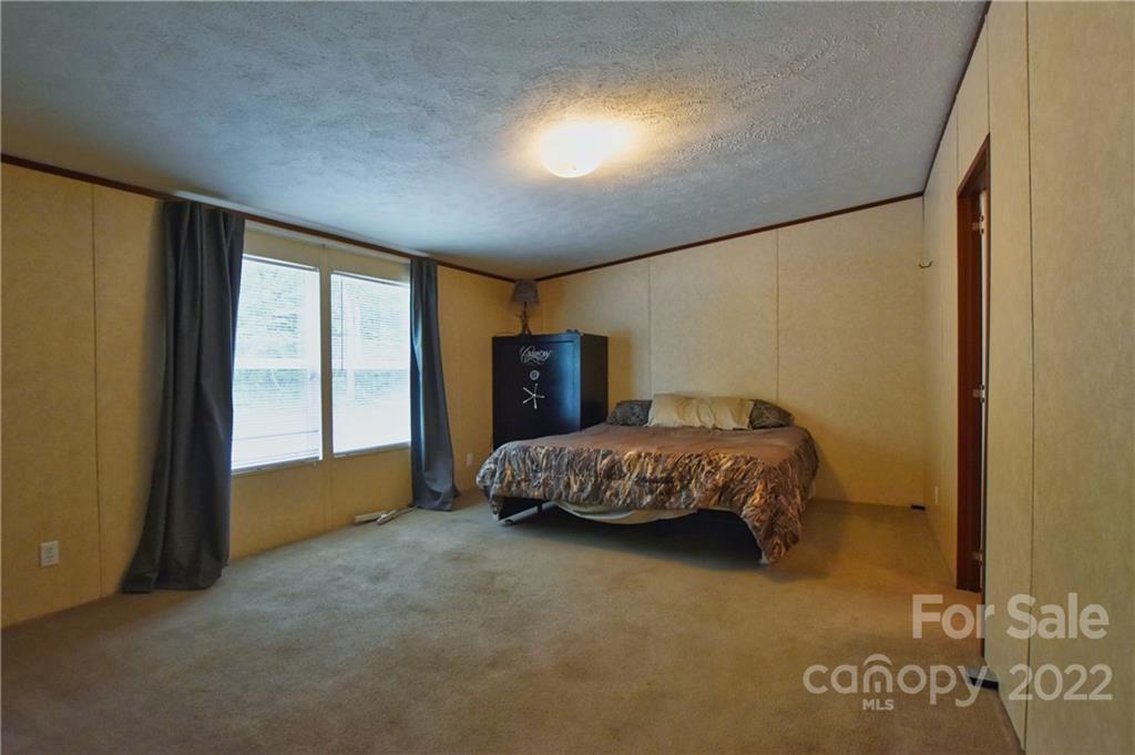 191 East Bells Branch Road Blacksburg, SC 29702 - Photo 7 of 14 a bedroom with a bed and large windows