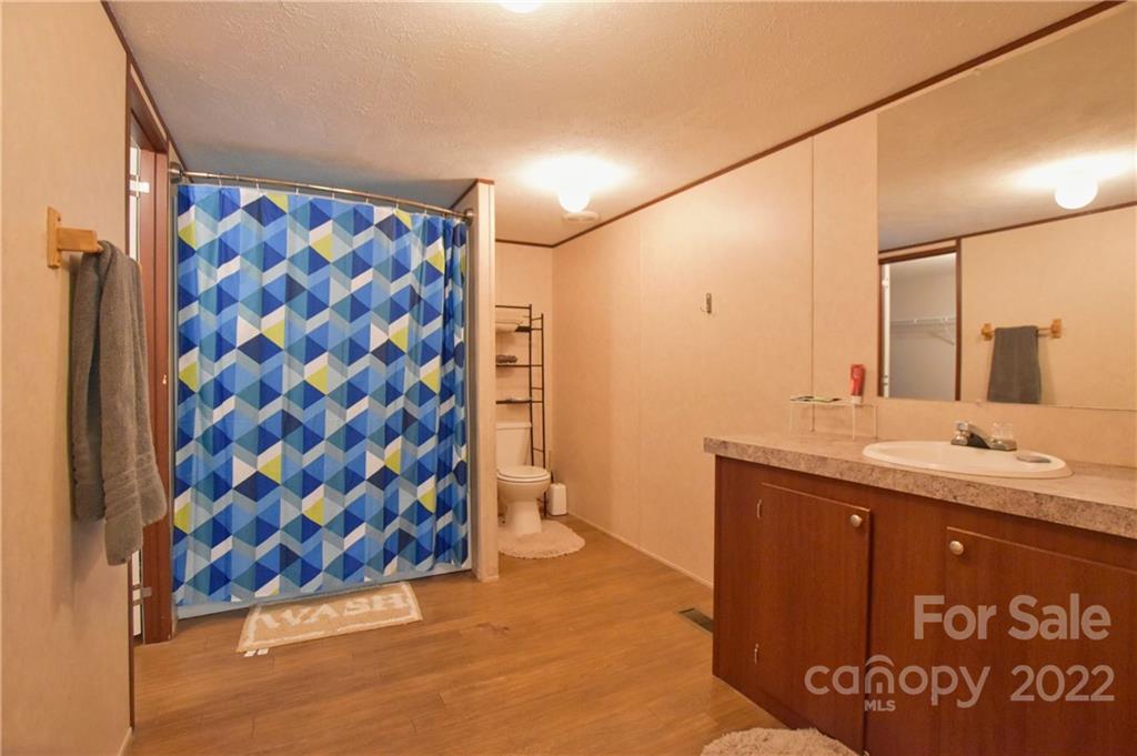 191 East Bells Branch Road Blacksburg, SC 29702 - Photo 8 of 14 a bathroom with a granite countertop sink a toilet and shower