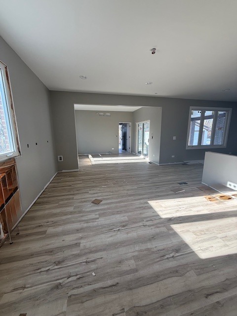 7128 Cork Avenue Justice, IL 60458 - Photo 4 of 17 a view of an empty room with wooden floor and a window