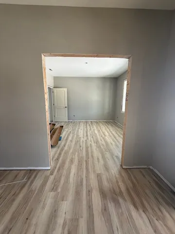 a view of a hallway with wooden floor