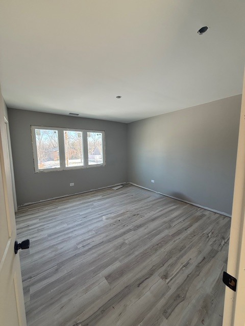 7128 Cork Avenue Justice, IL 60458 - Photo 8 of 17 a view of empty room with wooden floor and fan