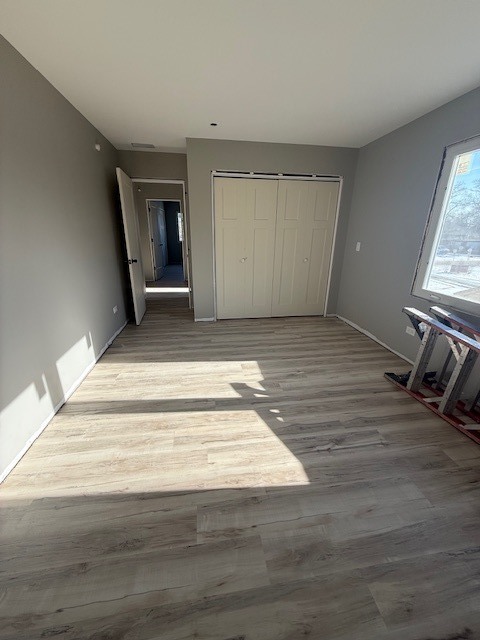 7128 Cork Avenue Justice, IL 60458 - Photo 9 of 17 a view of an empty room with wooden floor and a window