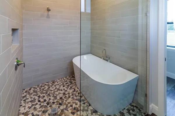 a bathroom with a bathtub and shower