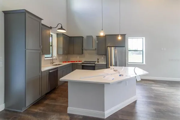 a kitchen with kitchen island white cabinets and stainless steel appliances