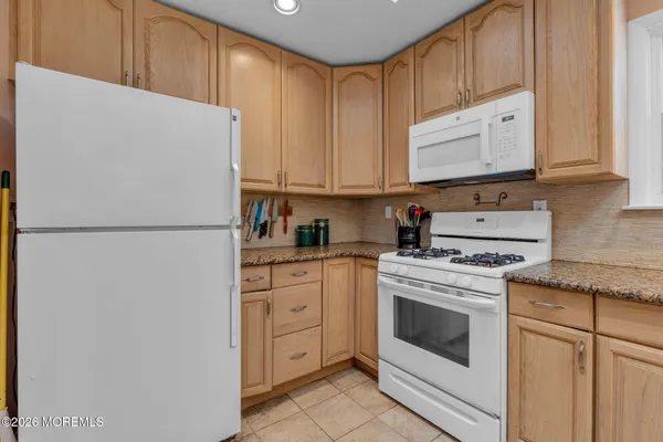 a kitchen with stainless steel appliances granite countertop white refrigerator stove a sink and dishwasher