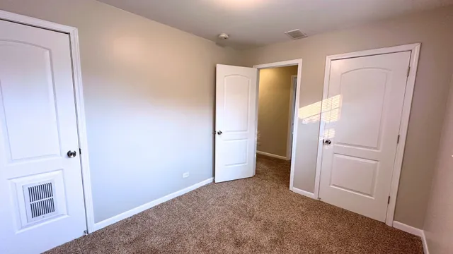 an empty room with a door and mirror