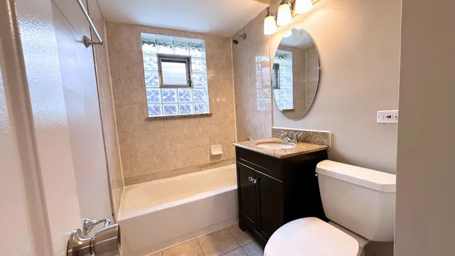 a bathroom with a toilet a sink and bathtub