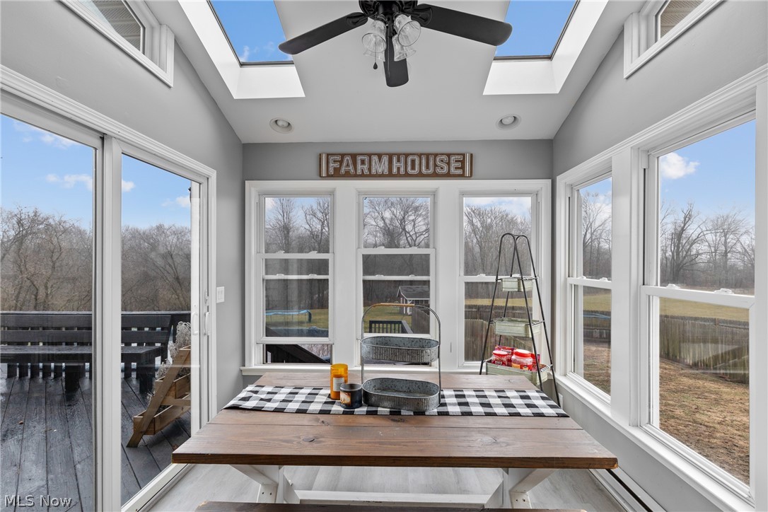 64508 Slade Road Cambridge, OH 43725 - Photo 14 of 50 Sunroom / solarium featuring lofted ceiling, a skylight, wood finished floors, and recessed lighting