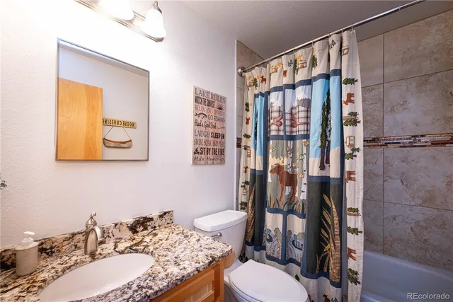 a view of a hallway with wooden floor and entryway