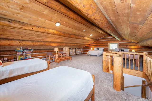 a balcony with wooden floor table and chairs
