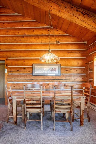 a view of a backyard with a dining table and chairs