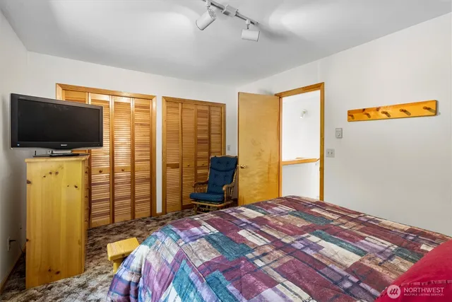 a bed sitting in a bedroom next to a window