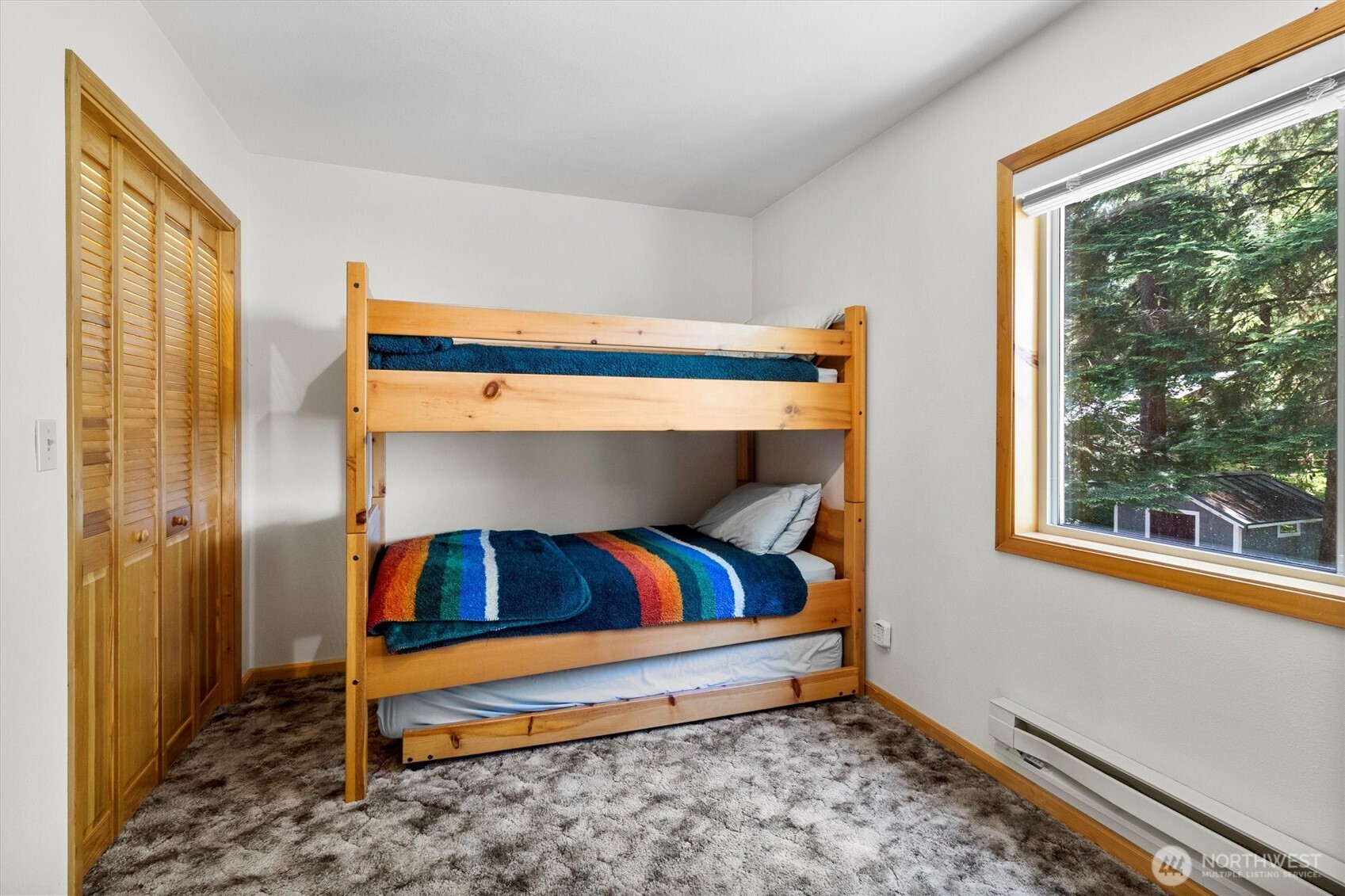 7101 Rainier Way Glacier, WA 98244 - Photo 23 of 38 a bedroom with a bed and a window
