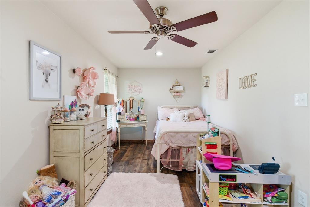 187 County Road 4195 Decatur, TX 76234 - Photo 23 of 40 a bed room with a bed and a baby bed