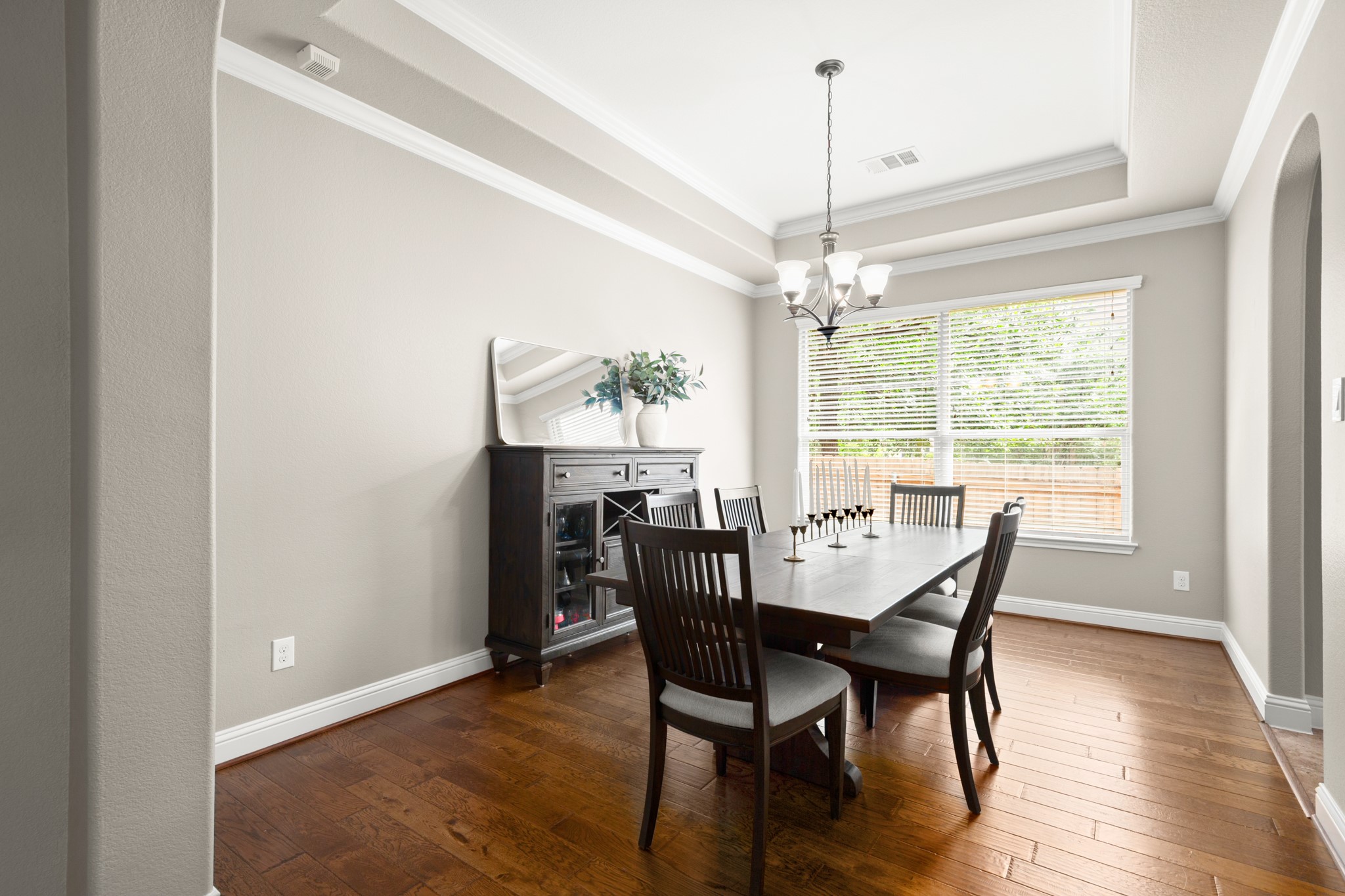 502 Spring Arbor Lane Cedar Park, TX 78613 - Photo 12 of 40 The formal dining room opens under a sweeping archway off the living room and comes wrapped in crown olding under tall tray ceilings.