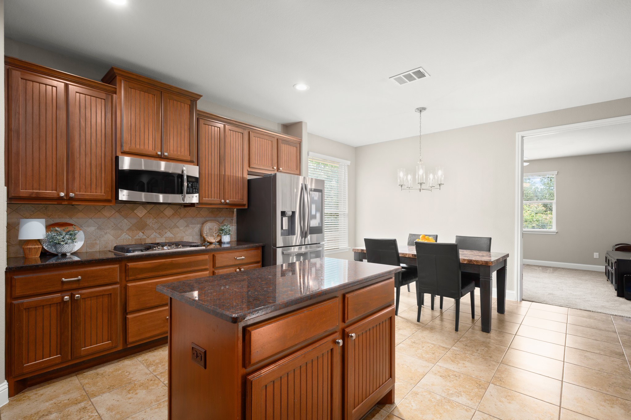 502 Spring Arbor Lane Cedar Park, TX 78613 - Photo 15 of 40 Featuring granite countertops, tile backsplash, and built-in stainless appliances.