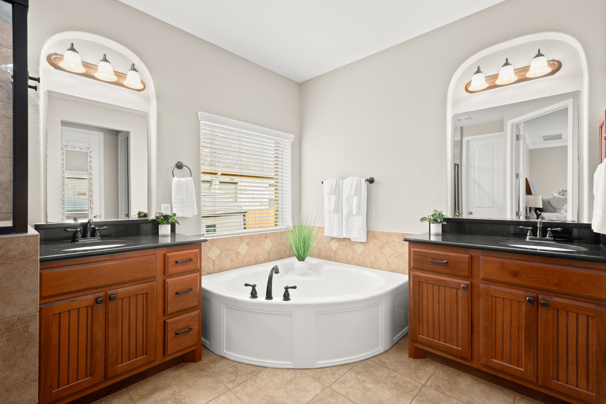 502 Spring Arbor Lane Cedar Park, TX 78613 - Photo 21 of 40 Enjoy your own private ensuite bath complete with separate vanities that flank a relaxing garden tub.