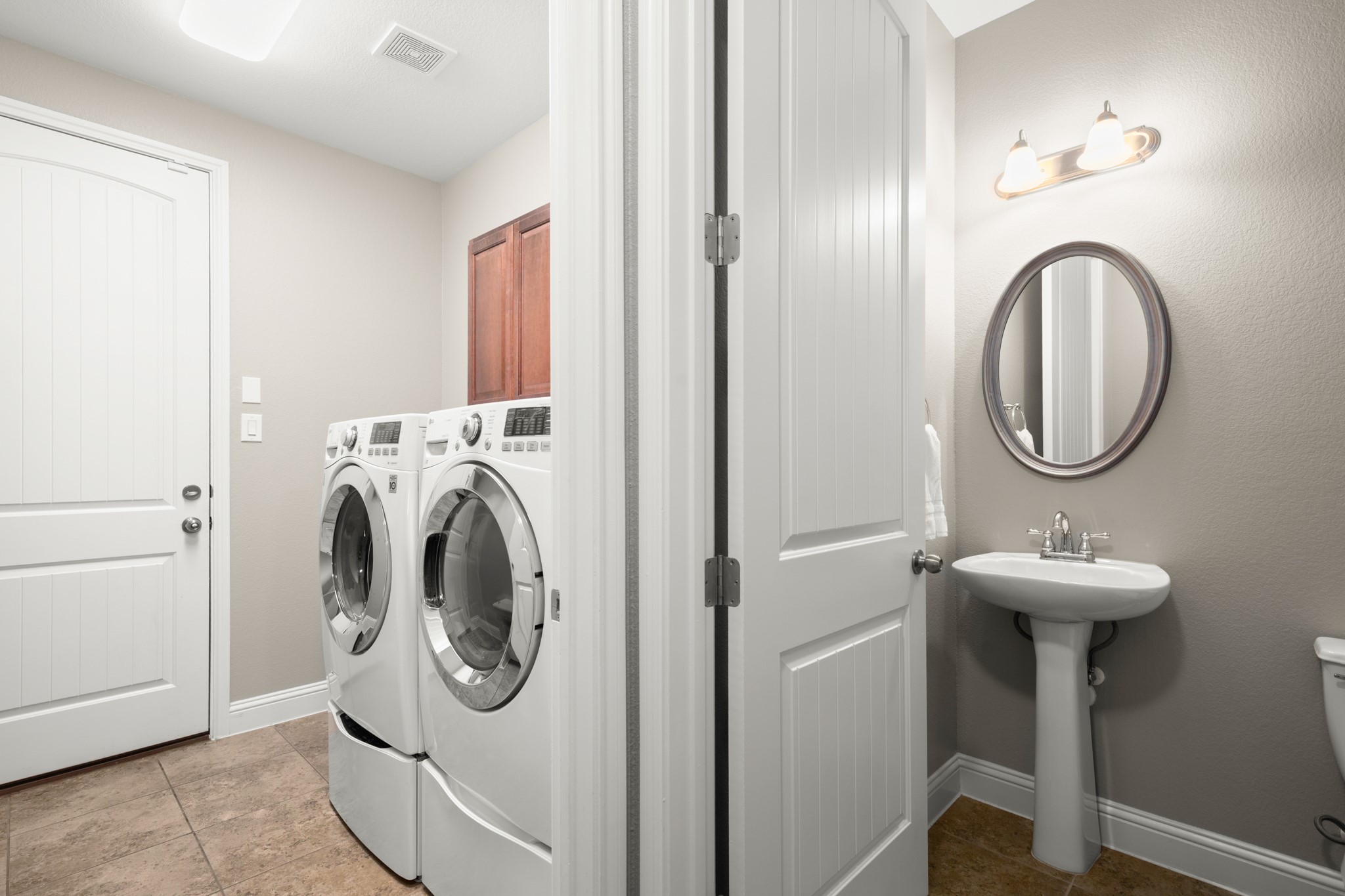 502 Spring Arbor Lane Cedar Park, TX 78613 - Photo 30 of 40 The in home laundry room, garage entry, and guest powder room are tucked away to the right of the rotunda.