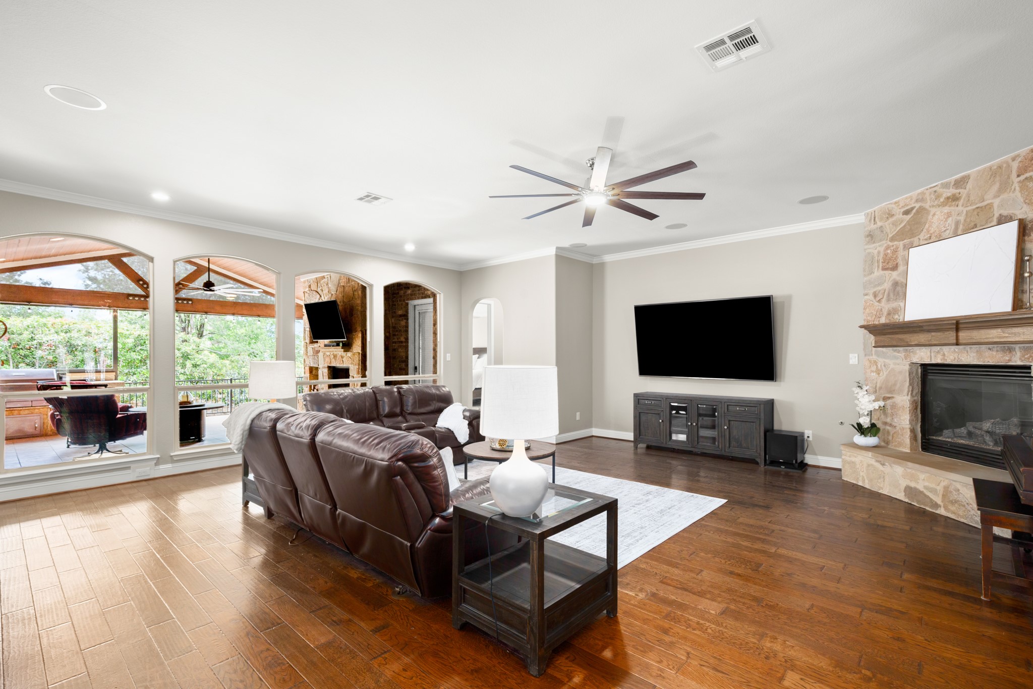 502 Spring Arbor Lane Cedar Park, TX 78613 - Photo 8 of 40 Luminous and oversized living room under tall ceilings wrapped in crown molding with a wall of arching windows.