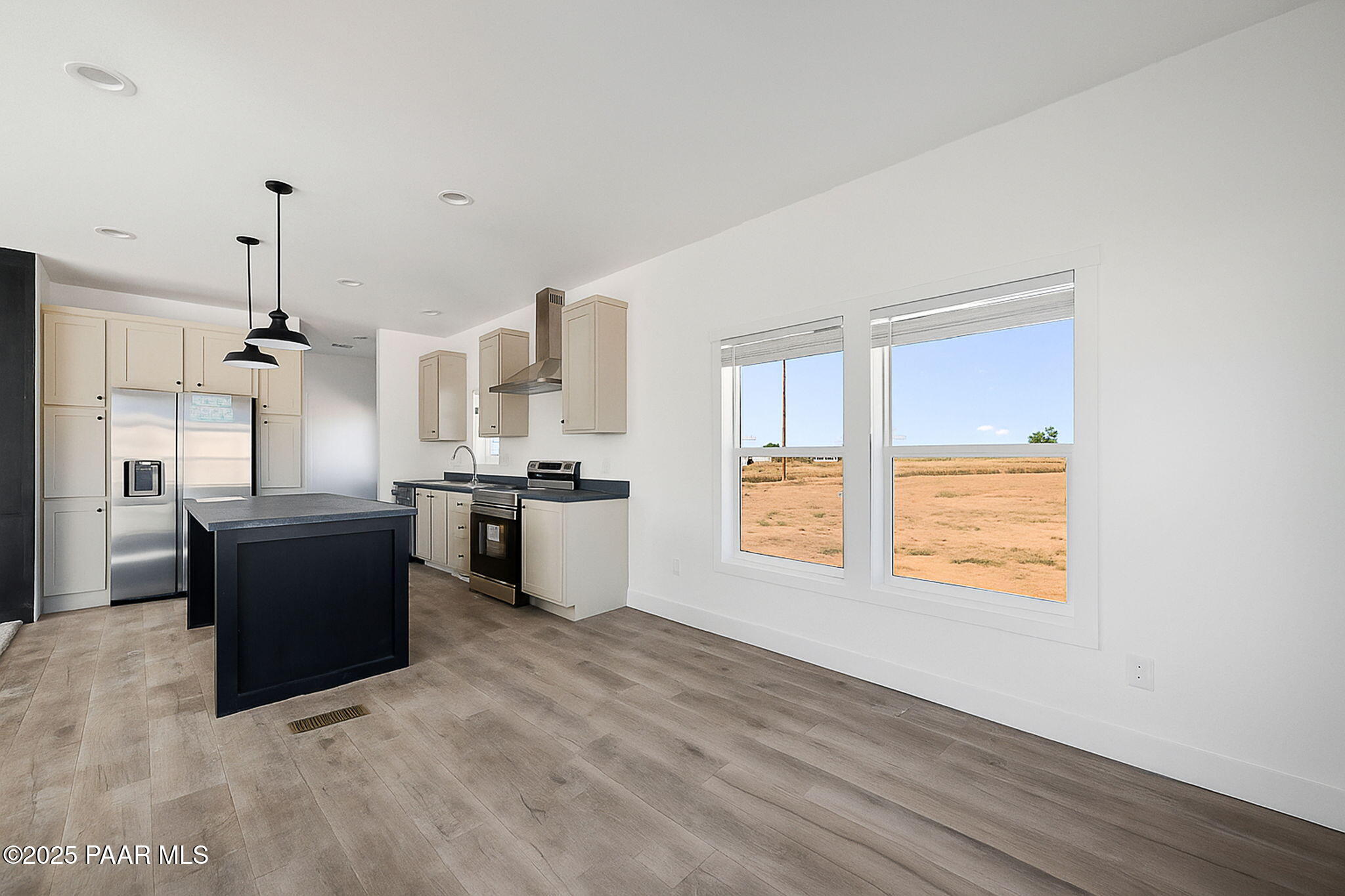 39 East Abra Road Paulden, AZ 86334 - Photo 8 of 23 a large open kitchen with a refrigerator a sink dishwasher and white cabinets with wooden floor
