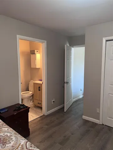 a living room with a bed and a window