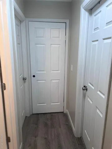 an empty room with wooden floor