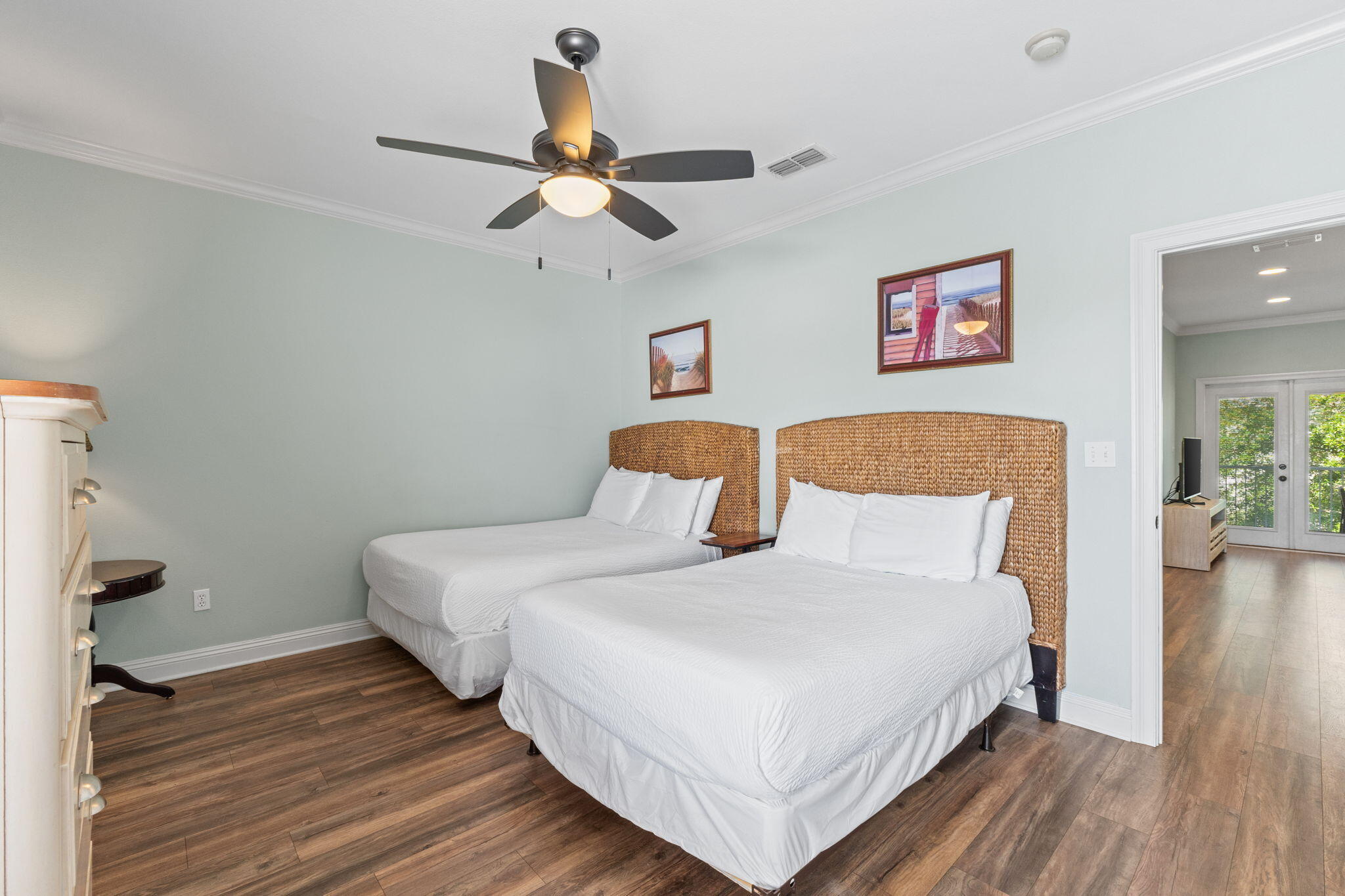 209 Grand Key Loop East Destin, FL 32541 - Photo 41 of 59 a bedroom with a bed and wooden floor