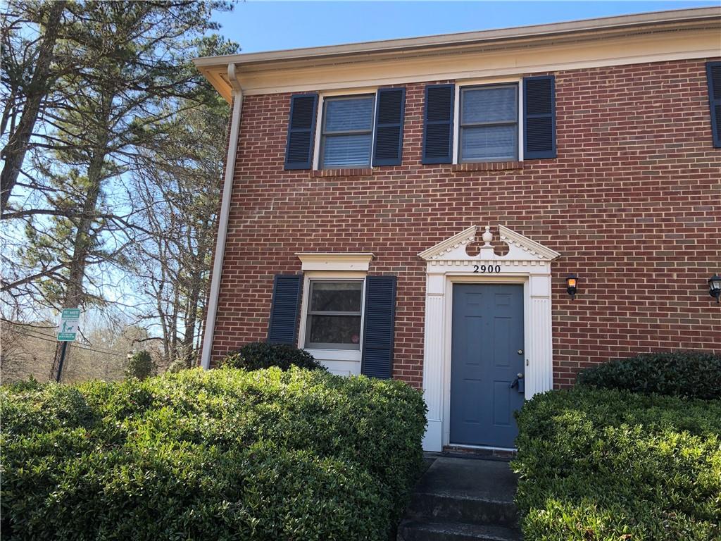 2900 Webb Bridge Road Alpharetta, GA 30009 - Photo 1 of 1 a front view of a house with garden