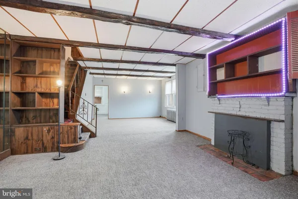 a view of an empty room with a staircase