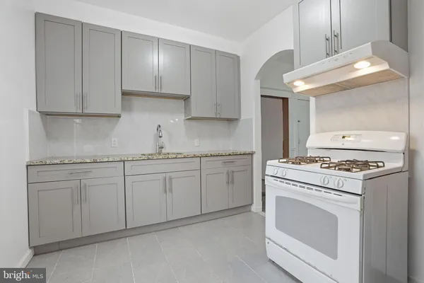 a kitchen with granite countertop cabinets stainless steel appliances and a sink