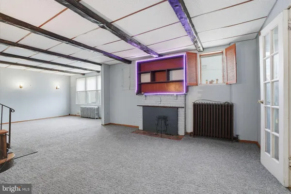 a view of a livingroom with an empty space and a fireplace