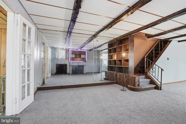 a view of an empty room with a staircase