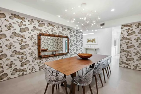 a kitchen with a stove and a wooden floor