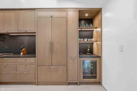 a spacious bedroom with a bed and a flat screen tv